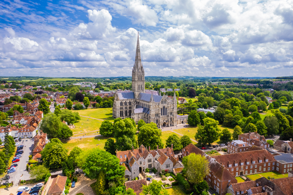 A stunning view of the Salisbury Cathedral and its surrounding greenery, highlighting cleanliness and charm.